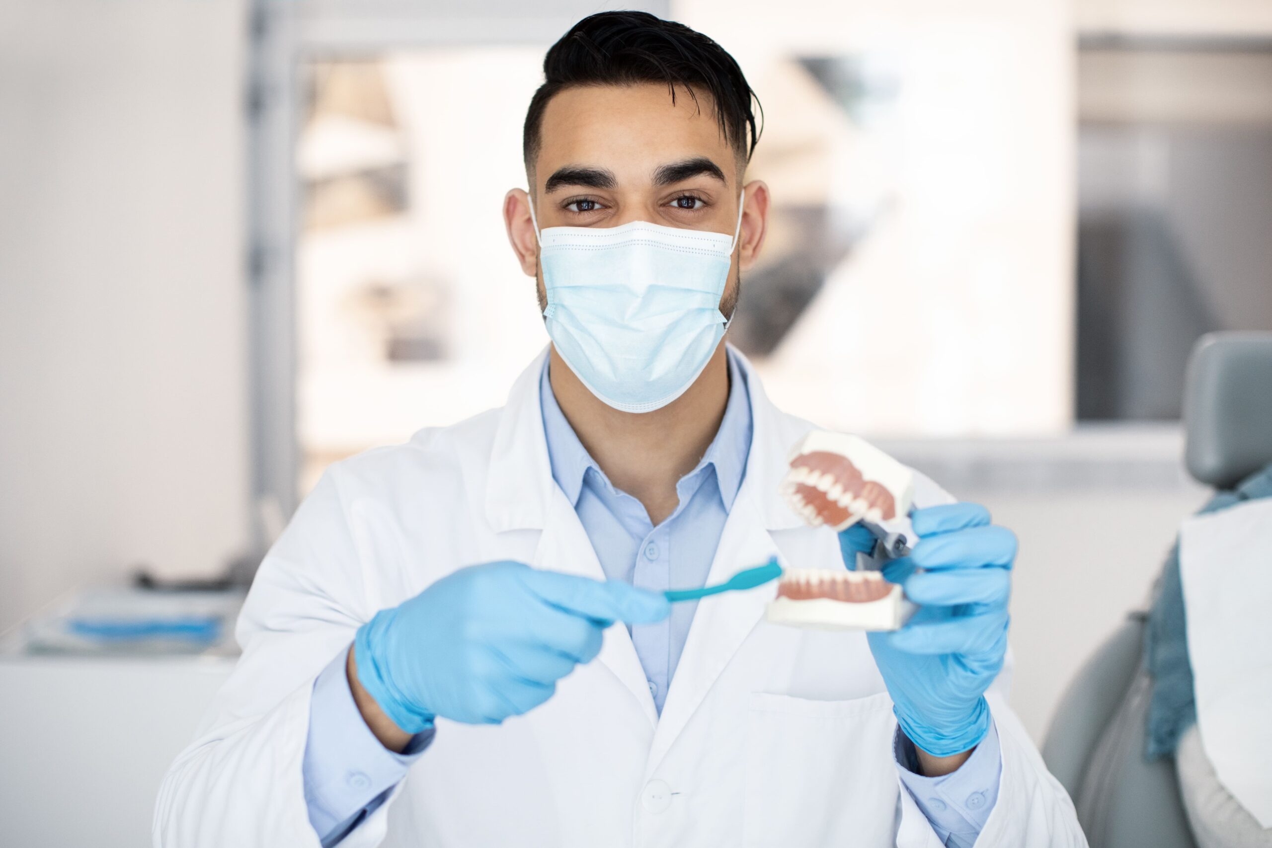 dentist showing model of teeth