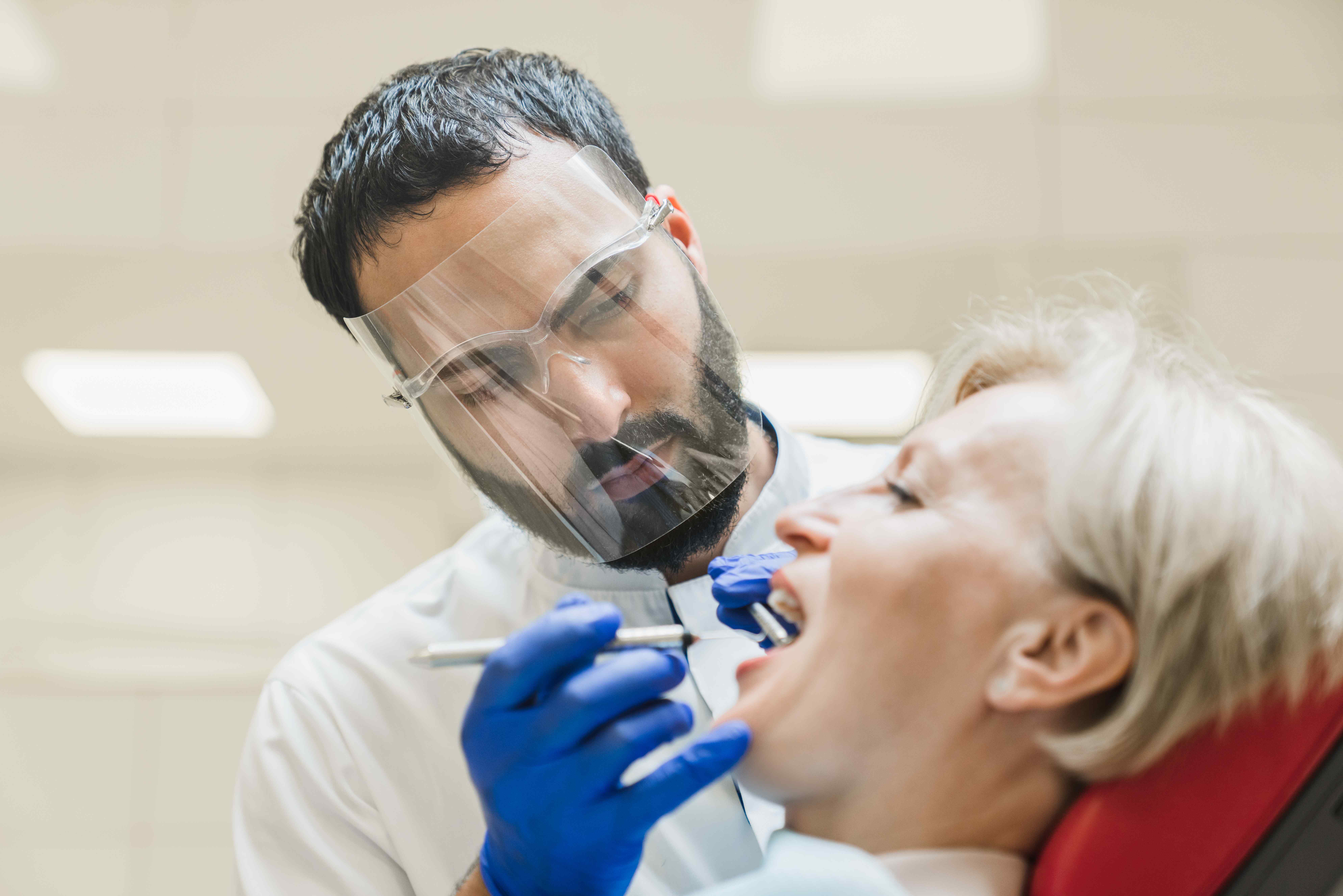 dentist performing oral health exam