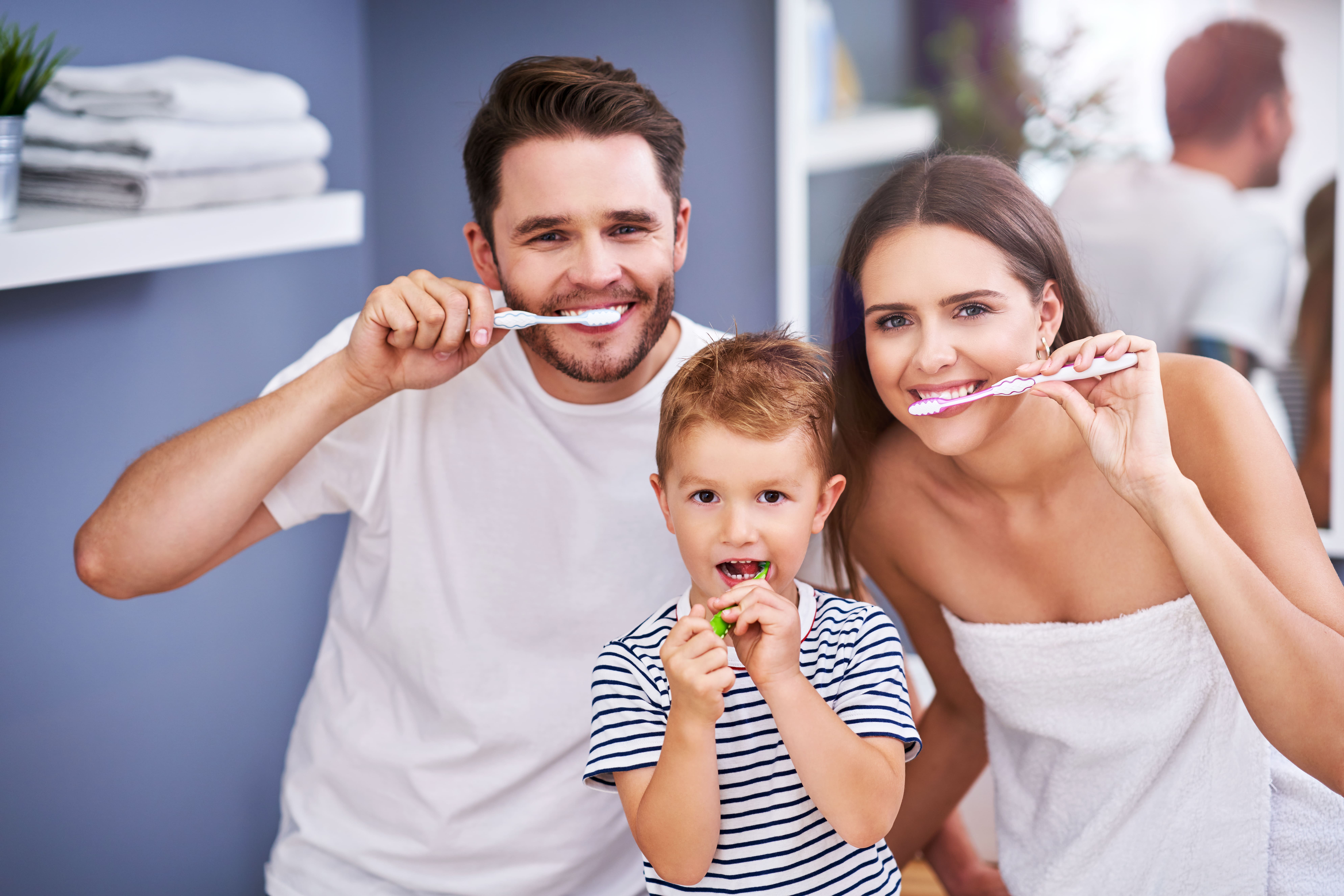 family brushing teeth in the bathroom